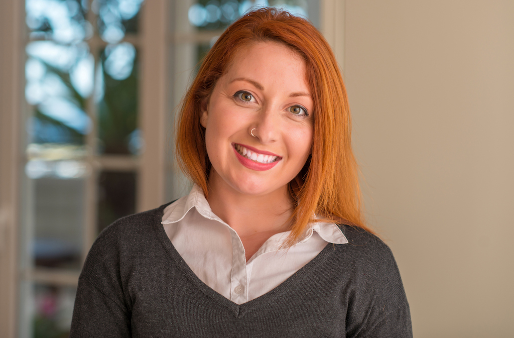 Happy red headed women smiling into camera at home. | Licensed Electricians
