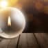 Candlelight inside a light bulb on a wooden table representing load shedding strategies to extend backup power runtime.